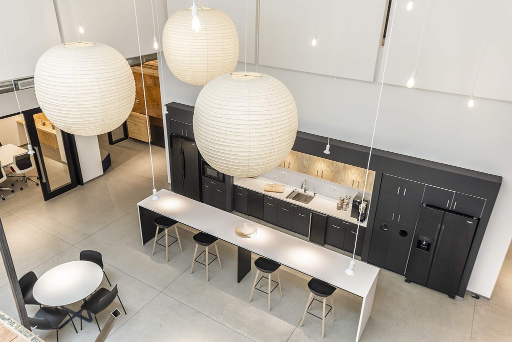 a large kitchen with three large paper lanterns hanging from the ceiling