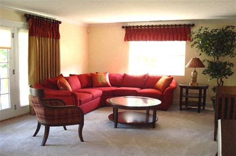 a living room with a red couch and a table