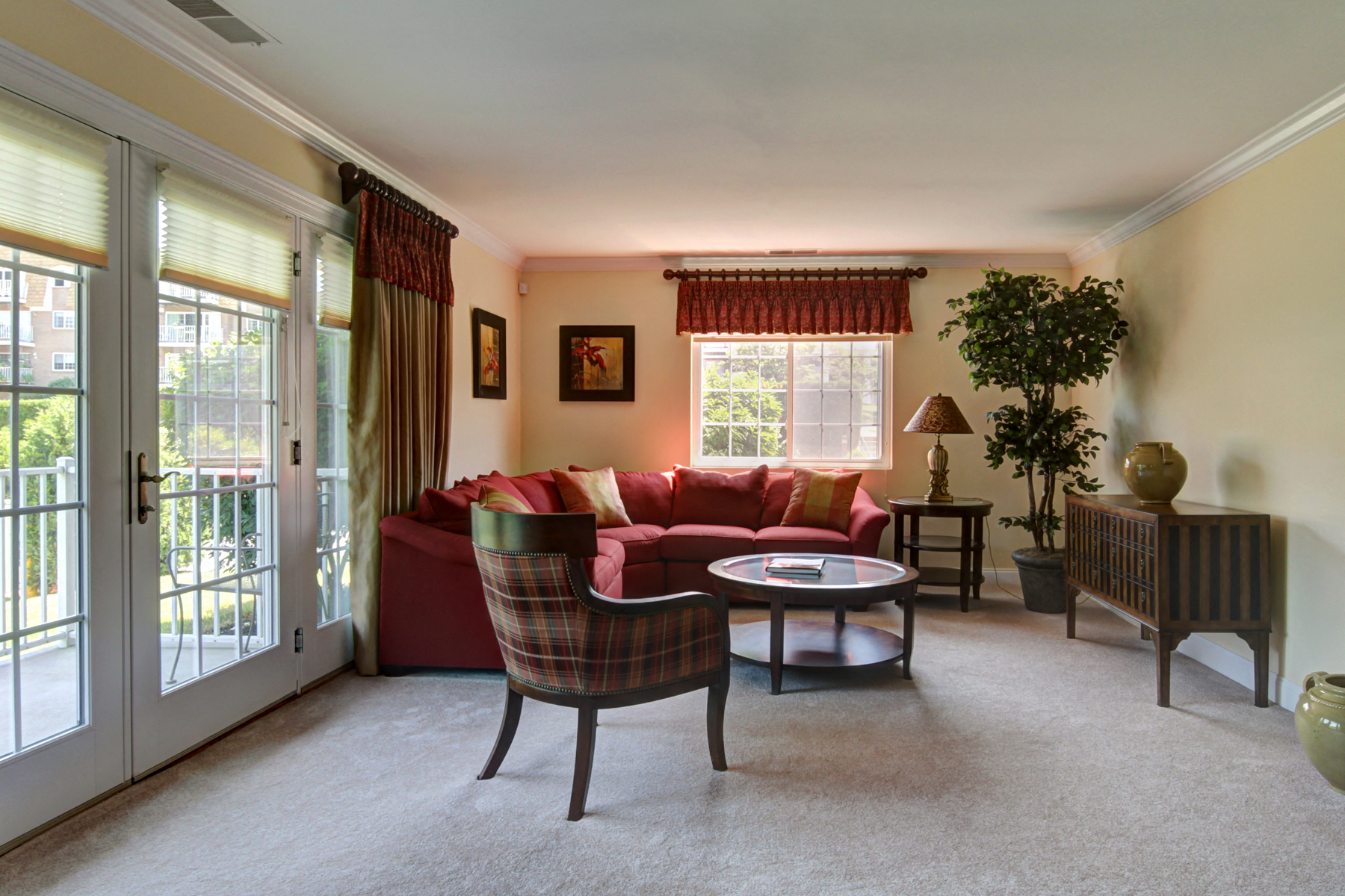 a living room with a red couch and a table