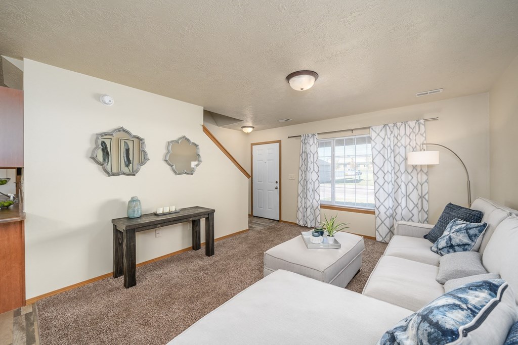 a living room with a white couch and a table