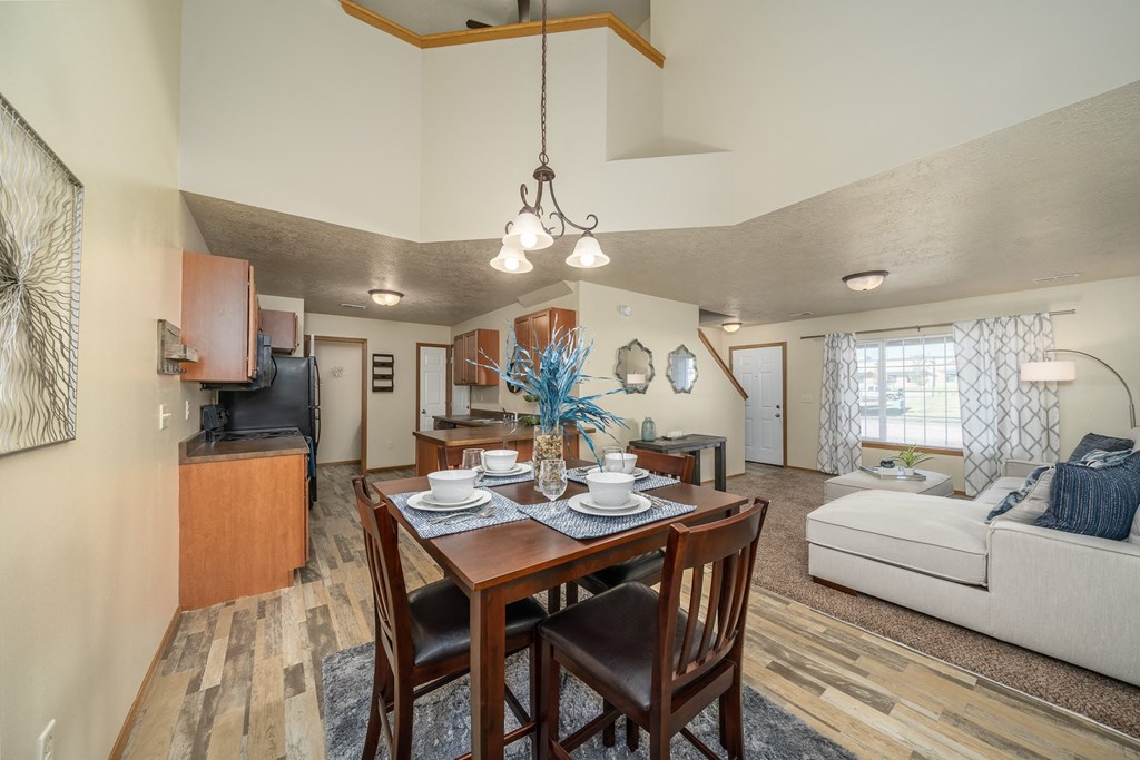 a dining room table with chairs next to a living room