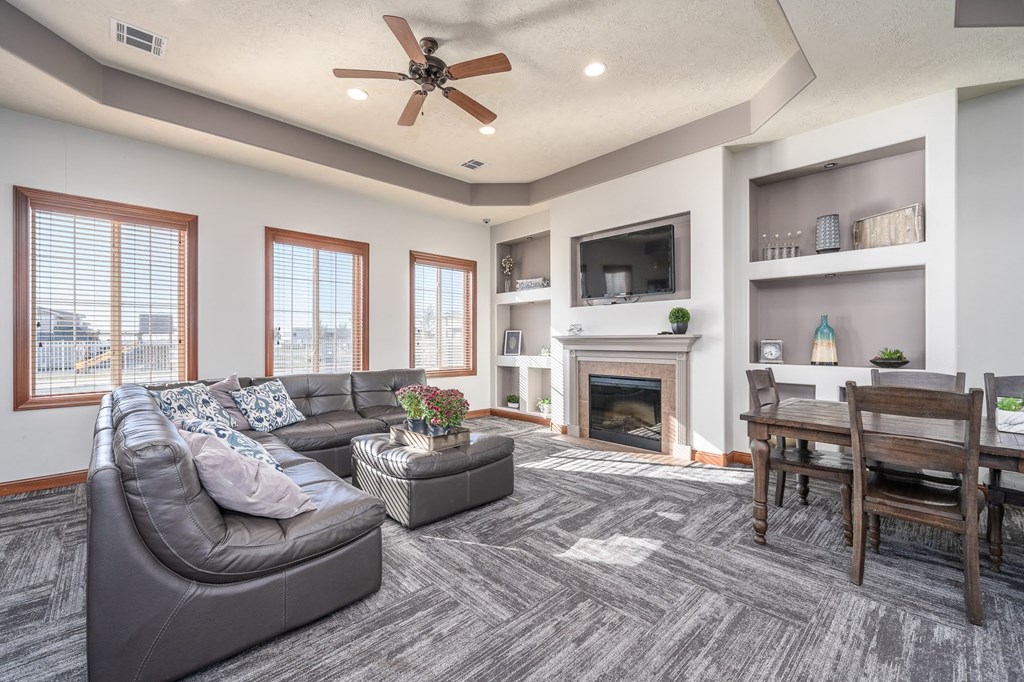 a living room with a couch and a table and a fireplace