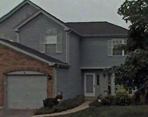 A grey house with a white garage door.