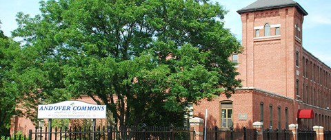 a large brick building with a tree in front of it