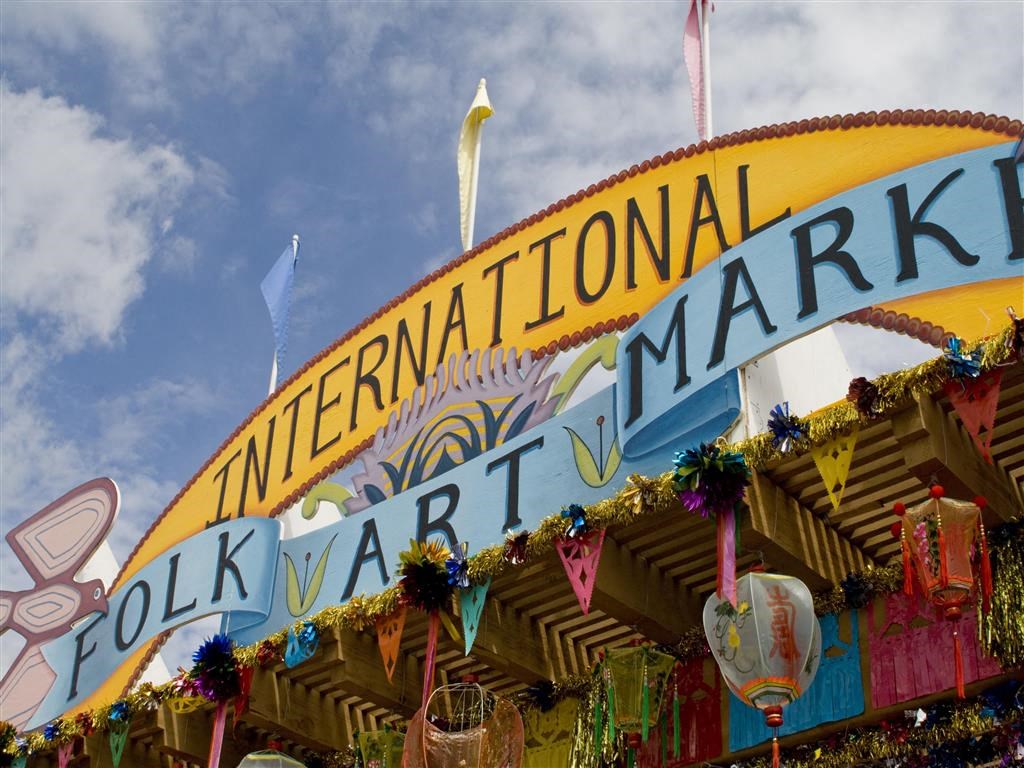 a fair with a sign that says international folk art market  at Altitude at Vizcaya, Santa Fe