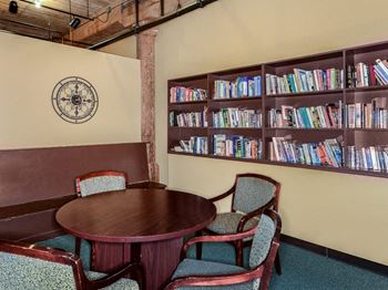a table and chairs in a room with a bookshelf at Bigelow Commons, Connecticut