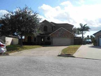 a house with a driveway and a car parked in front of it