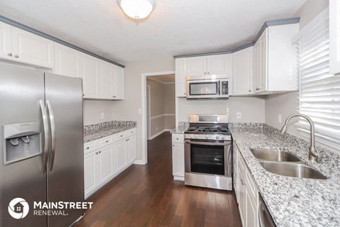 a kitchen with granite counter tops and stainless steel appliances