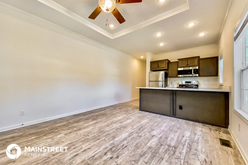 the living room is open to the kitchen and dining area