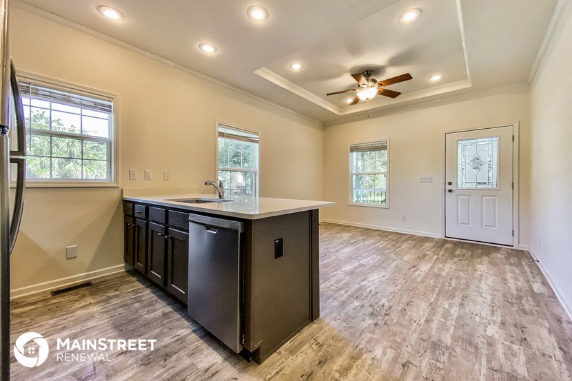 the kitchen is open to the dining room and living room