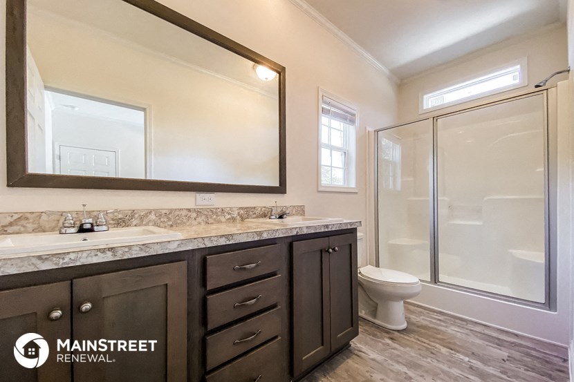 a bathroom with a sink and a toilet and a shower