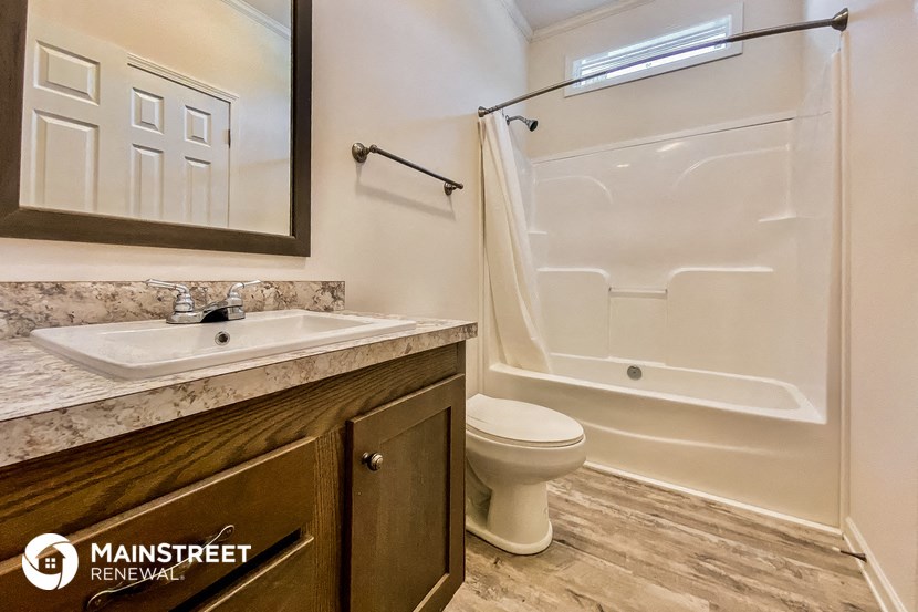 a bathroom with a sink and a toilet and a shower