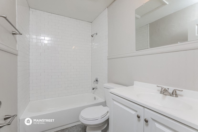 a white bathroom with a sink toilet and bath tub