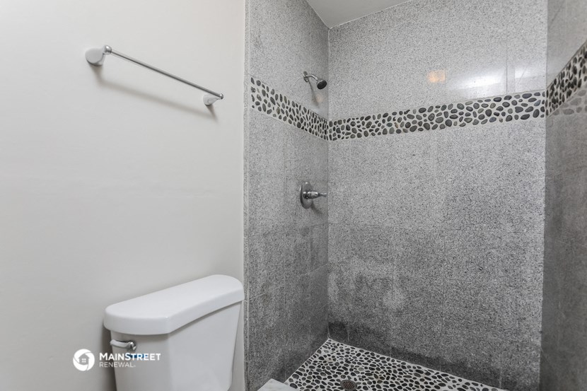 a small bathroom with a toilet and a shower