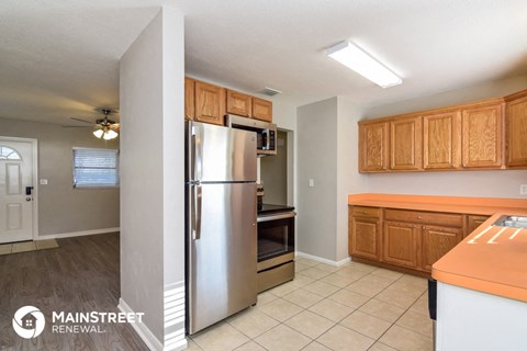 a kitchen with stainless steel appliances and wooden cabinets