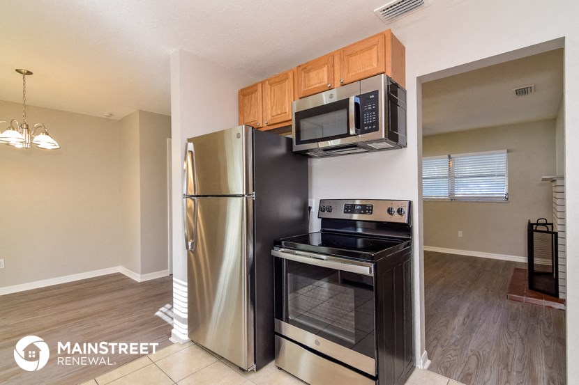 a kitchen with stainless steel appliances and a refrigerator