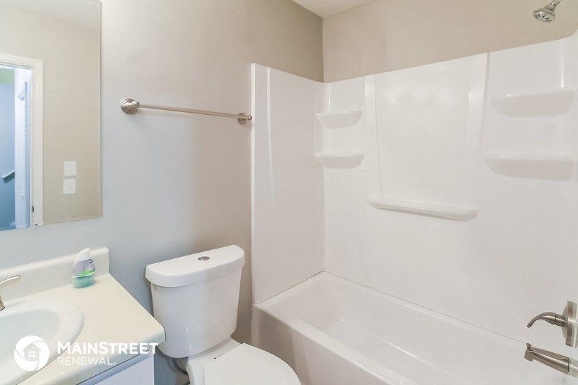 a bathroom with a shower and a sink and a toilet