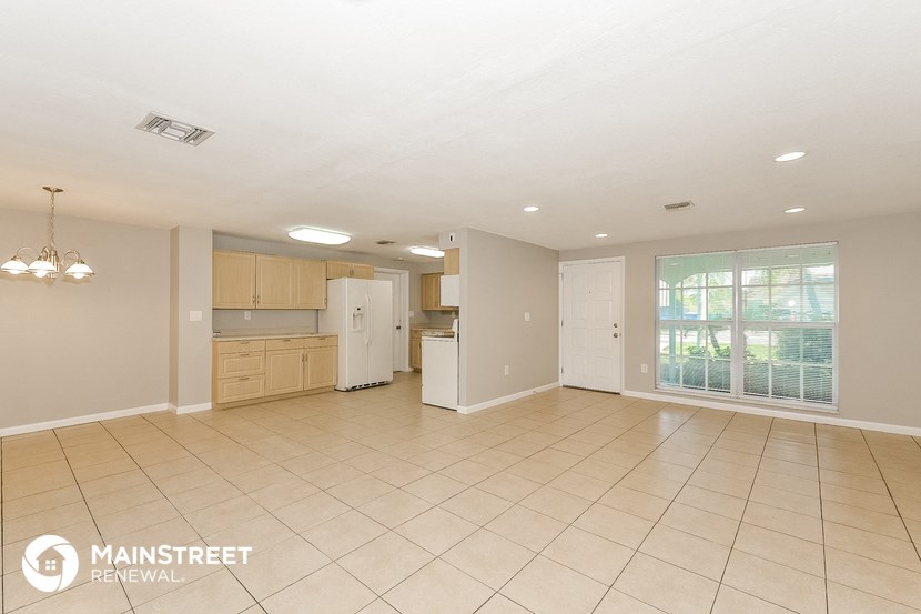 the kitchen and living room of this manufactured home are spacious and clean