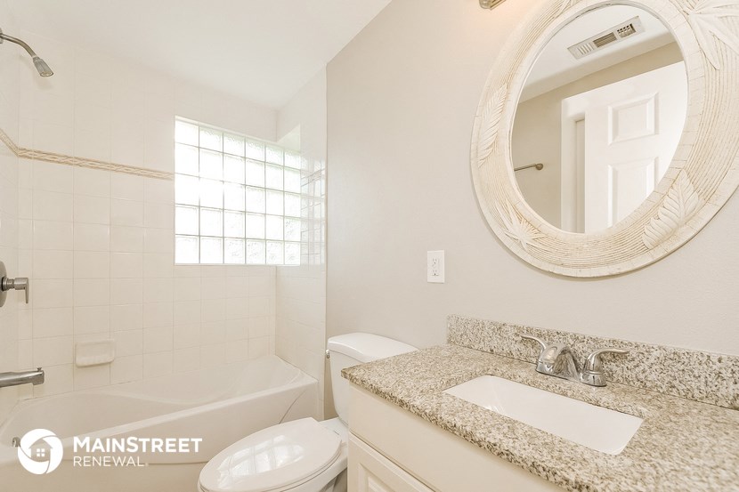 a bathroom with a sink and a toilet and a mirror