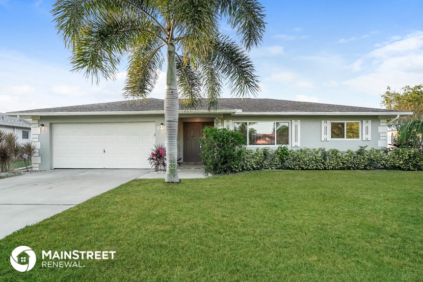 a home with a palm tree in front of it
