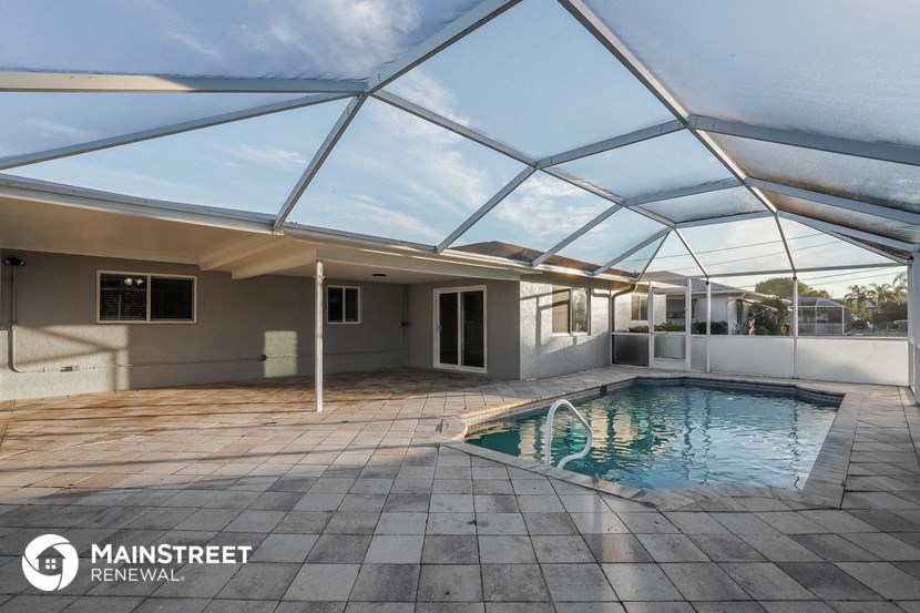 a covered pool with a glass roof on top of it