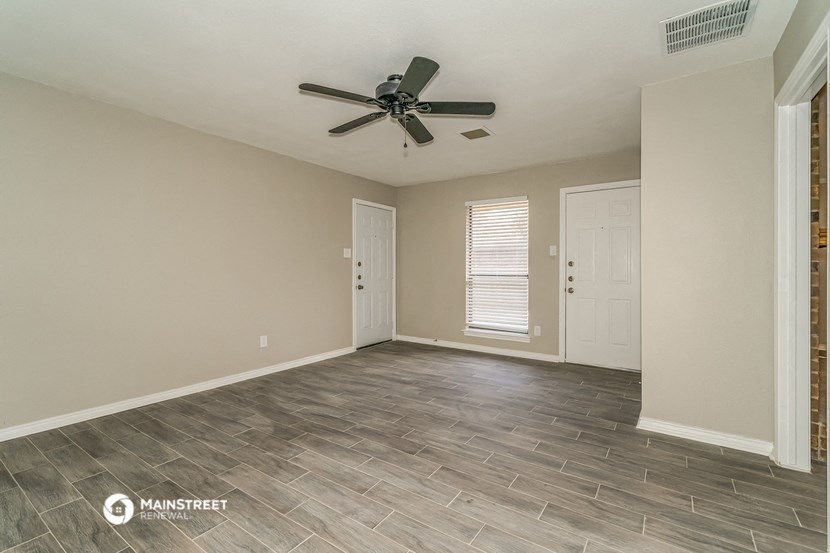 the living room of a home with a ceiling fan