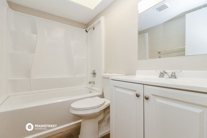 a bathroom with a sink toilet and a bath tub