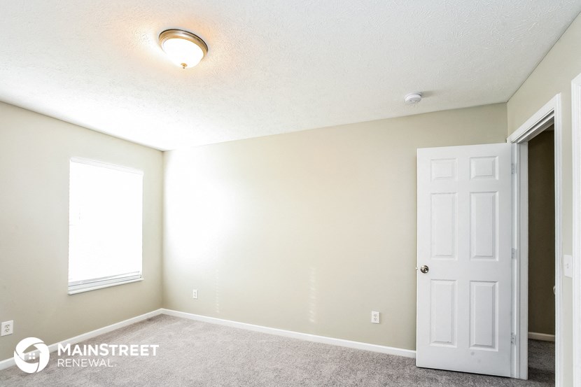 the upstairs bedroom has a closet and a door to the bathroom