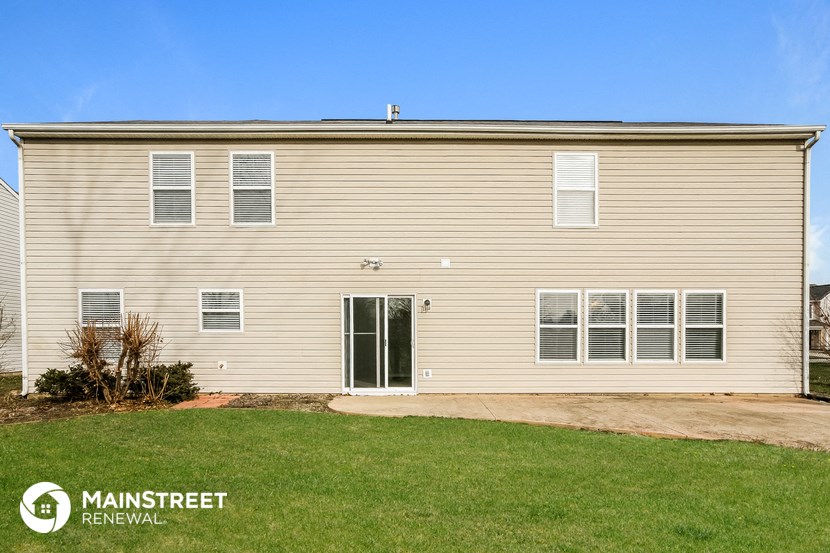 the exterior of a house with a yard in front of it