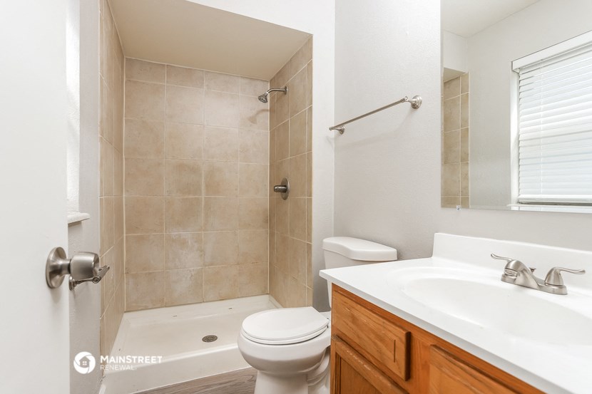 a bathroom with a sink toilet and a shower