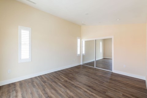 a living room with a hard wood floor and white walls
