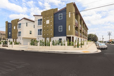 a row of apartment buildings on a street corner