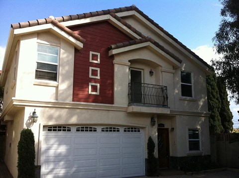 a red and white house with a garage door