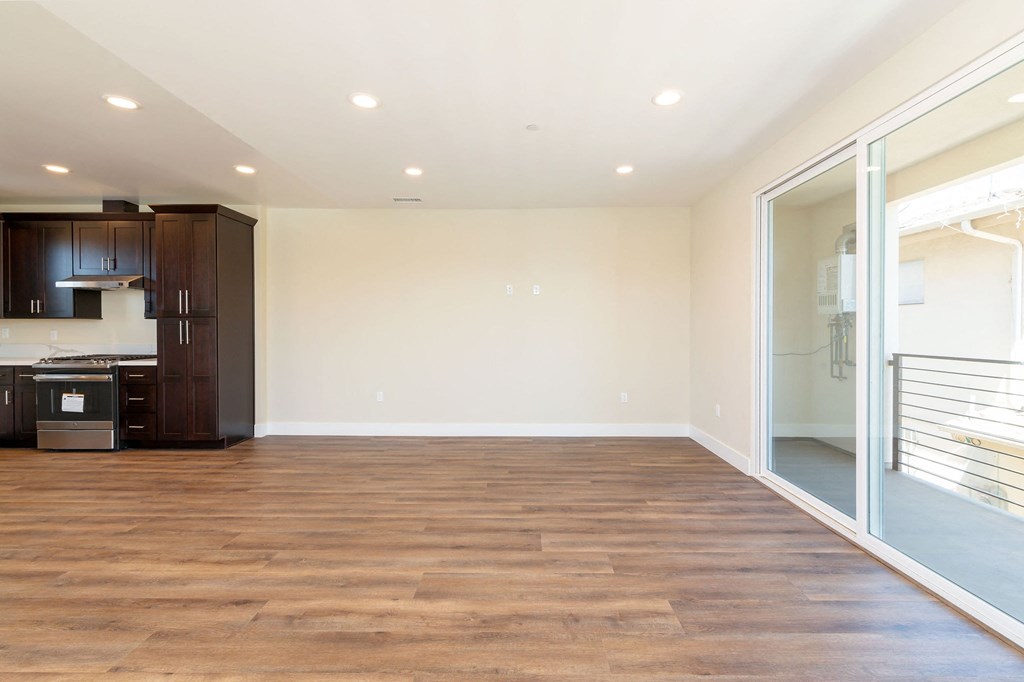 a living room with a hardwood floor and a sliding glass door