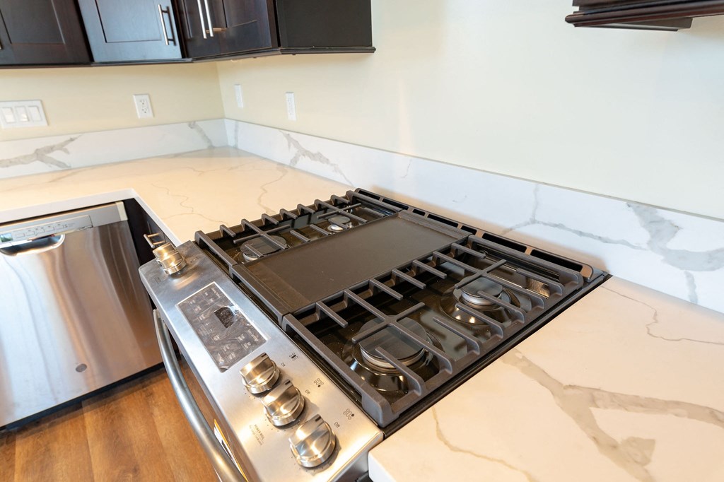 a kitchen with a stove top oven and a refrigerator