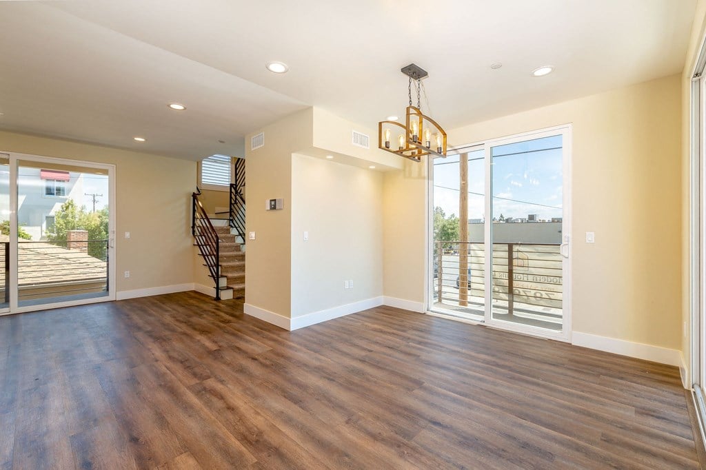 a living room with a large window and a chandelier