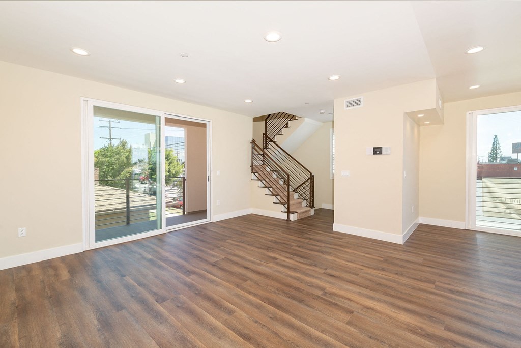 a living room with a hard wood floor and a staircase