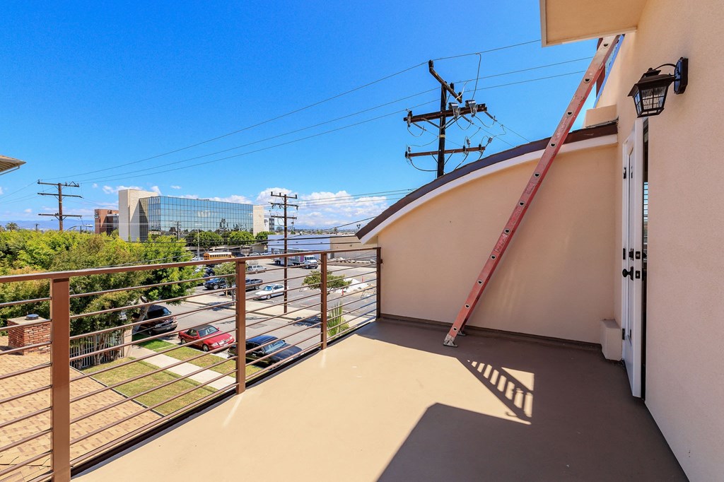 a balcony with a view of the city and a ladder on the side