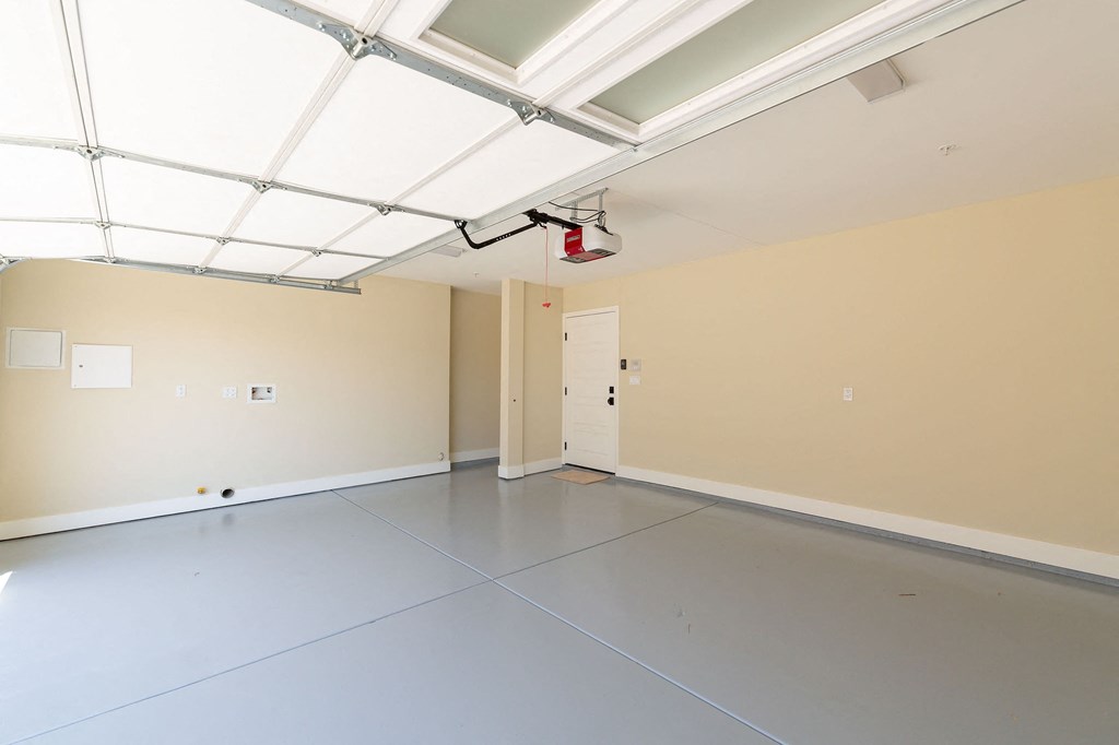 the interior of an empty garage with a gray floor and white walls