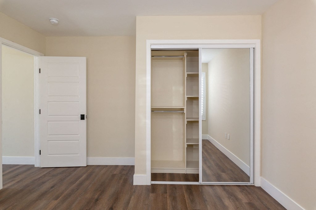 a bedroom with a closet and an open door