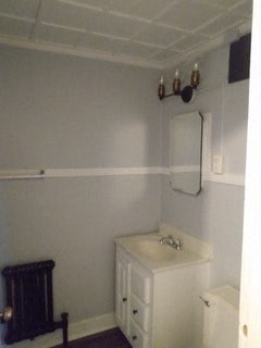 a white bathroom with a sink and a mirror