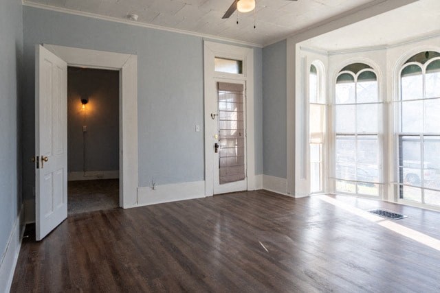 an empty living room with wood floors and a door
