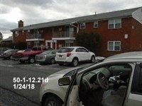 a car parked in a parking lot in front of a building