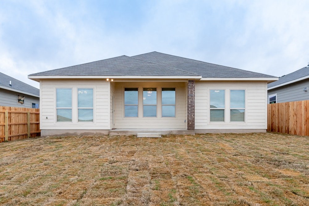 a small white house with a yard in front of it