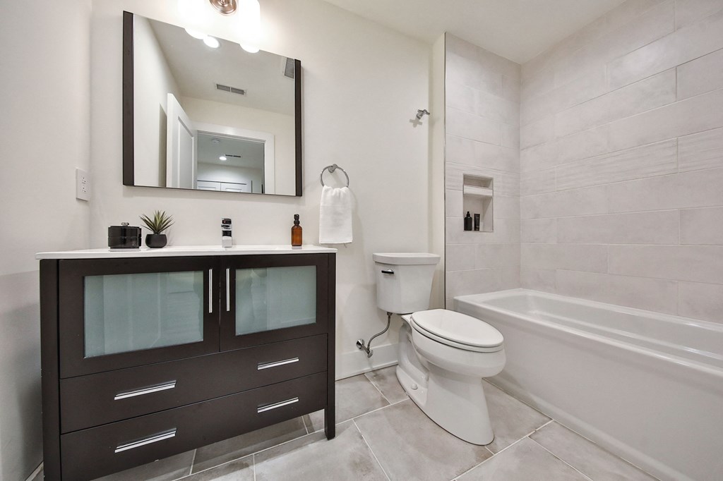 a bathroom with a toilet and a sink and a bath tub