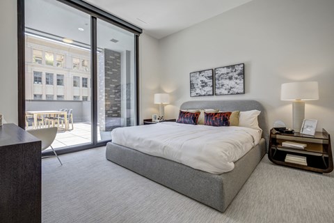 a bedroom with a bed and a large window
