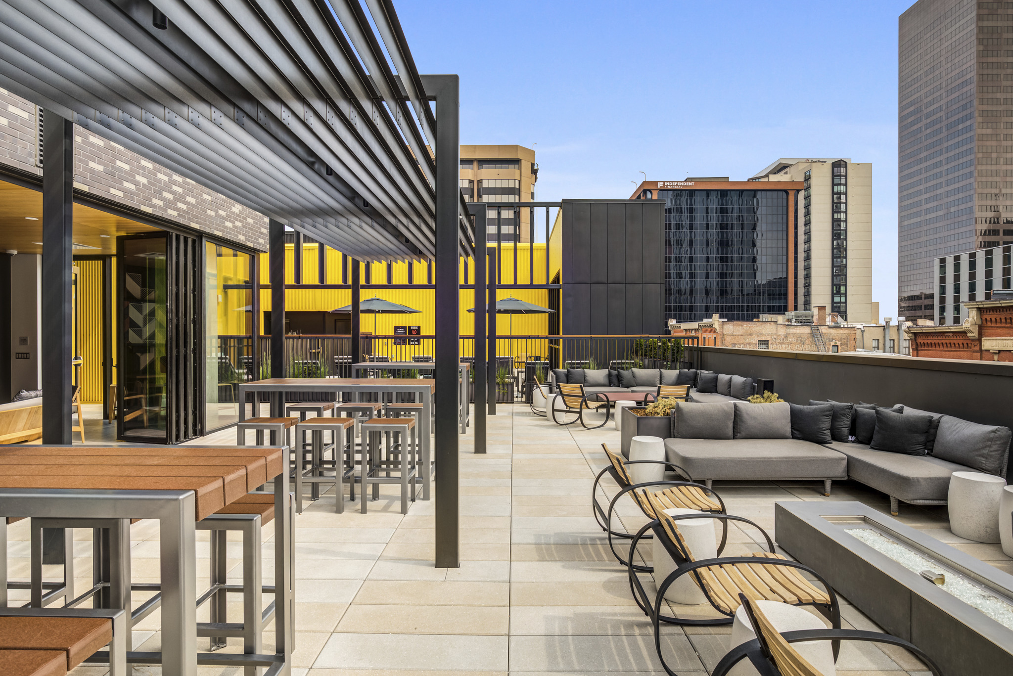 a rendering of a rooftop patio with tables and chairs