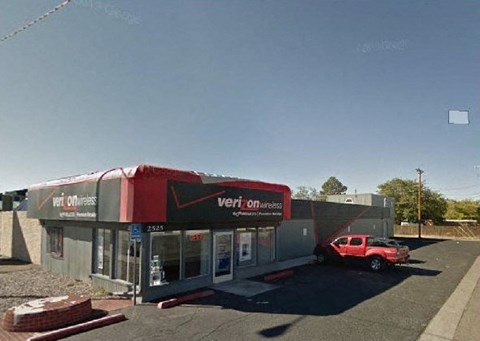 A Verizon store with a red truck parked in front.