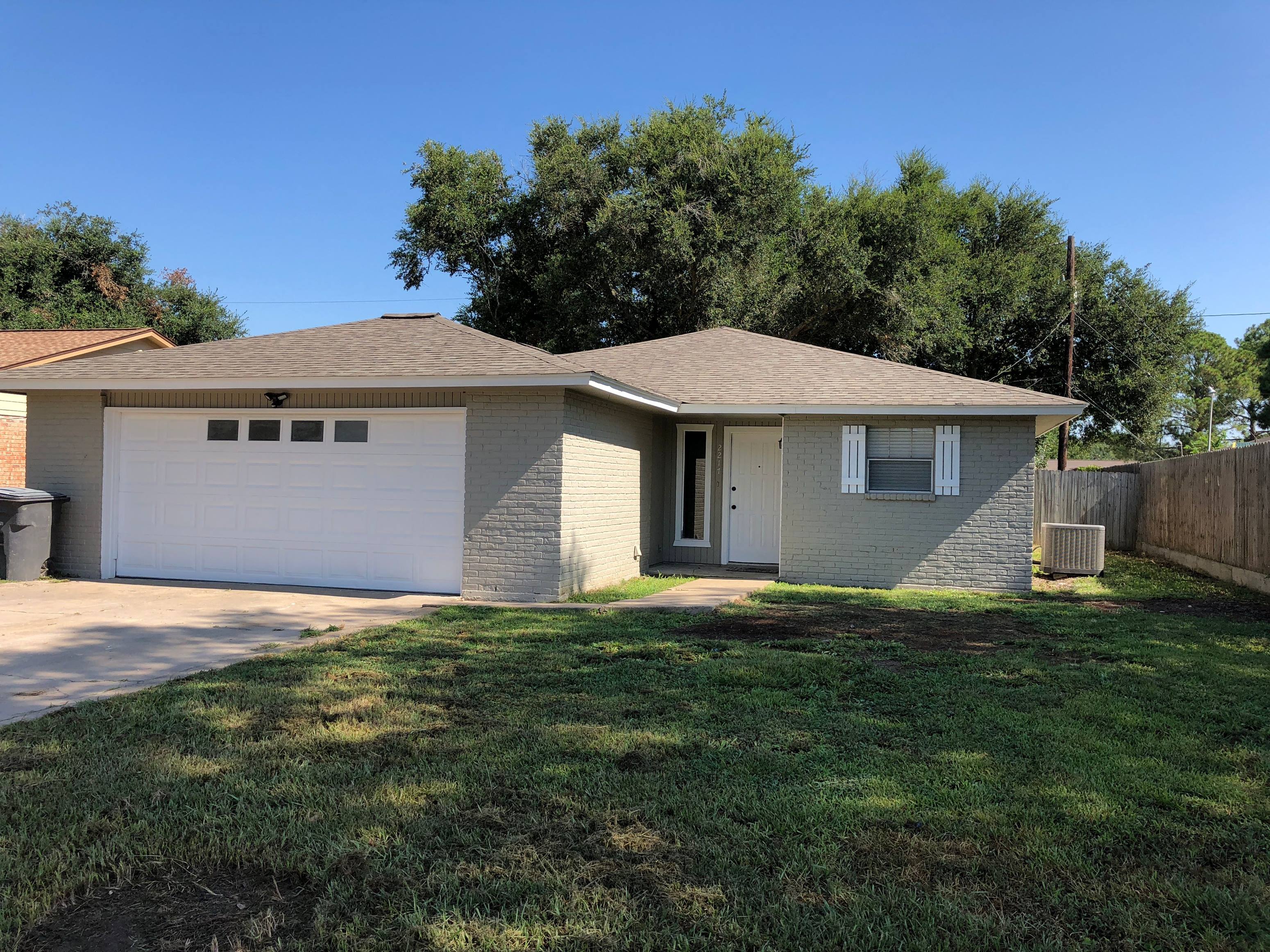 A house with a brown roof and a white garage door.