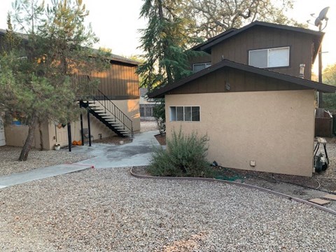 a house with a gravel driveway in front of it